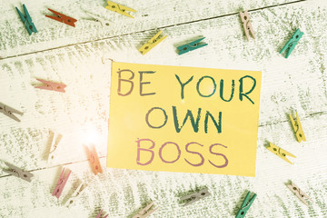 Conceptual hand writing showing Be Your Own Boss. Concept meaning Entrepreneurship Start business Independence Selfemployed Colored clothespin rectangle shaped paper blue background