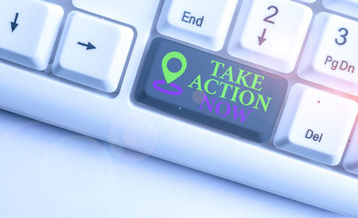 Text sign showing Take Action Now. Business photo text asking someone to start doing Good perforanalysisce Encourage White pc keyboard with empty note paper above white background key copy space