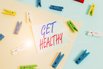 Text sign showing Get Healthy. Business photo showcasing possessing or enjoying good health or a sound mentality Colored clothespin paper empty reminder yellow blue floor background office