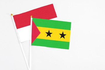 Sao Tome And Principe and Indonesia stick flags on white background. High quality fabric, miniature national flag. Peaceful global concept.White floor for copy space.