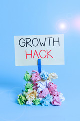 Word writing text Growth Hack. Business photo showcasing generally to acquire as analysisy users or customers as possible Reminder pile colored crumpled paper clothespin reminder blue background