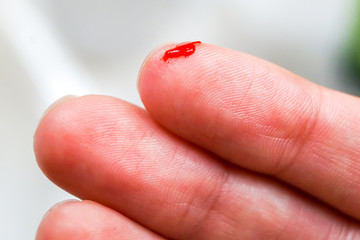 cut finger macro, blood is coming, drawing of fingerprints large, close, pain, cut from paper, messy, bleeding                              