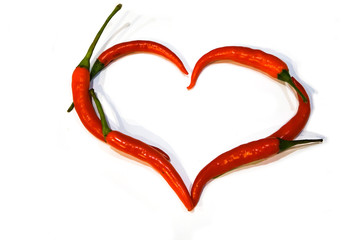 heart laid out of red chili peppers, shape, unusual, Valentine's day, isolate, spices, love hurts and bites, tasty and hot, pattern on white background