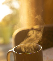 Steam coming from morning mug of coffee 