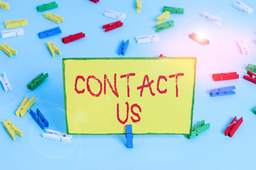 Word writing text Contact Us. Business photo showcasing Term used to describe reaching out with the business or demonstrating Colored clothespin papers empty reminder blue floor background office pin