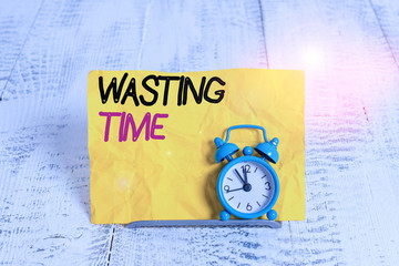 Word writing text Wasting Time. Business photo showcasing act of spending time doing something that...