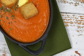 Overhead view of homemade Tomato and Carrot Soup topped .