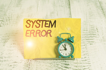 Word writing text System Error. Business photo showcasing instruction that is not recognized by an operating system Mini blue alarm clock stand tilted above buffer wire in front of notepaper