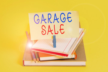 Conceptual hand writing showing Garage Sale. Concept meaning sale of miscellaneous household goods often held in the garage Book pencil rectangle shaped reminder notebook clothespins