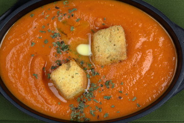 Overhead view of homemade Tomato and Carrot Soup topped .