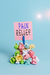 Text sign showing Pain Relief. Business photo showcasing Drugs or other methods of reducing or getting rid of pain Reminder pile colored crumpled paper clothespin reminder blue background