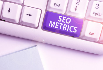 Conceptual hand writing showing Seo Metrics. Concept meaning measure the perforanalysisce of website for organic search results White pc keyboard with note paper above the white background