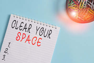 Writing note showing Clear Your Space. Business concept for Clean office studio area Make it empty Refresh Reorganize Blank empty notebook and stationary placed above pastel colour backdrop