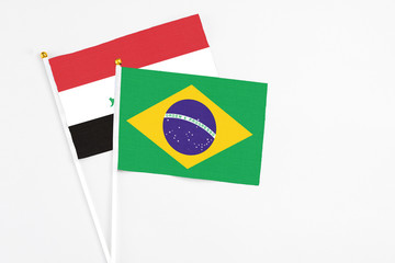 Brazil and Iraq stick flags on white background. High quality fabric, miniature national flag....