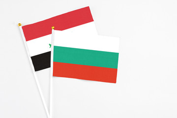 Bulgaria and Iraq stick flags on white background. High quality fabric, miniature national flag. Peaceful global concept.White floor for copy space.