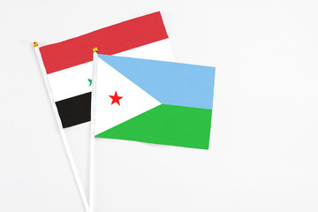 Djibouti and Iraq stick flags on white background. High quality fabric, miniature national flag....