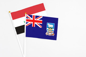 Falkland Islands and Iraq stick flags on white background. High quality fabric, miniature national...