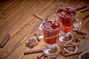 two glasses of mulled wine on a wooden surface
