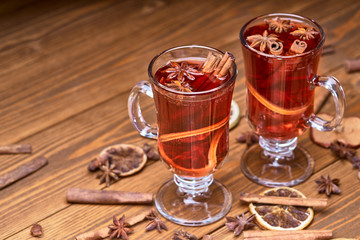 two glasses of mulled wine on a wooden surface