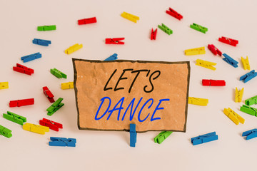 Handwriting text writing Let S Is Dance. Conceptual photo move rhythmically to music following a set sequence of steps Colored clothespin papers empty reminder white floor background office