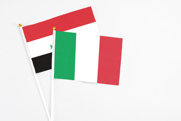 Italy and Iraq stick flags on white background. High quality fabric, miniature national flag. Peaceful global concept.White floor for copy space.