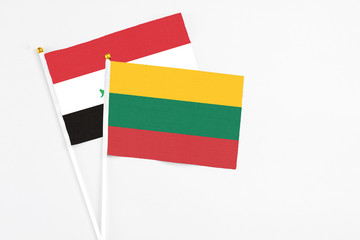 Lithuania and Iraq stick flags on white background. High quality fabric, miniature national flag. Peaceful global concept.White floor for copy space.
