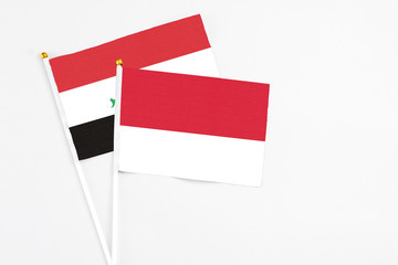 Monaco and Iraq stick flags on white background. High quality fabric, miniature national flag. Peaceful global concept.White floor for copy space.