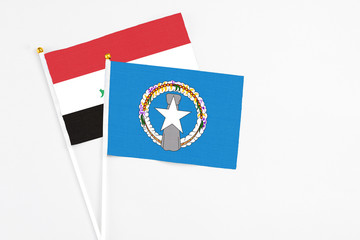 Northern Mariana Islands and Iraq stick flags on white background. High quality fabric, miniature national flag. Peaceful global concept.White floor for copy space.