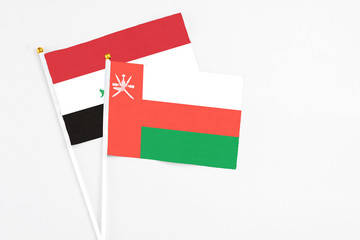 Oman and Iraq stick flags on white background. High quality fabric, miniature national flag. Peaceful global concept.White floor for copy space.