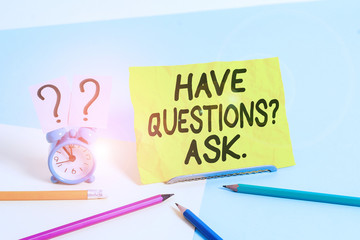 Text sign showing Have Questionsquestion Ask. Business photo text something that you say or write to ask a demonstrating Mini size alarm clock beside stationary placed tilted on pastel backdrop