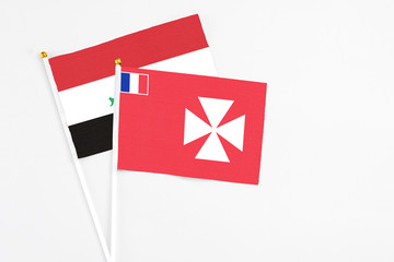 Wallis And Futuna and Iraq stick flags on white background. High quality fabric, miniature national flag. Peaceful global concept.White floor for copy space.