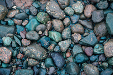 wet rocks on the ocean floor in blue hues