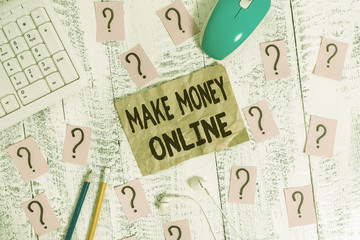 Text sign showing Make Money Online. Business photo showcasing Ecommerce Trading Selling over the internet Freelance Writing tools, computer stuff and scribbled paper on top of wooden table