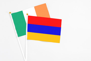 Armenia and Ireland stick flags on white background. High quality fabric, miniature national flag. Peaceful global concept.White floor for copy space