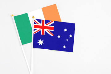 Fototapeta premium Australia and Ireland stick flags on white background. High quality fabric, miniature national flag. Peaceful global concept.White floor for copy space