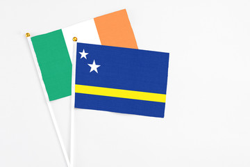 Curacao and Ireland stick flags on white background. High quality fabric, miniature national flag. Peaceful global concept.White floor for copy space