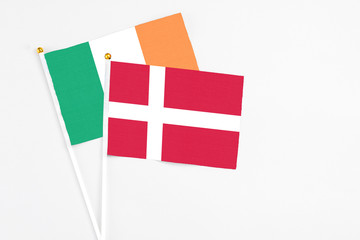 Denmark and Ireland stick flags on white background. High quality fabric, miniature national flag. Peaceful global concept.White floor for copy space