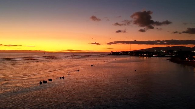 Beautiful sunset at Honolulu, Oahu, Hawaii with ocean and city view. Drone footage