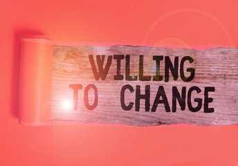 Word writing text Willing To Change. Business photo showcasing Desire to grow Eager to accept and adopt new ideas Cardboard which is torn in the middle placed above a wooden classic table