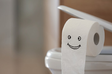 Modern toilet bowl with paper in bathroom, closeup. Space for text