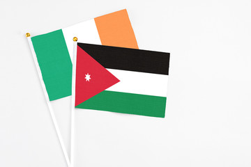 Jordan and Ireland stick flags on white background. High quality fabric, miniature national flag. Peaceful global concept.White floor for copy space