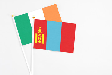 Mongolia and Ireland stick flags on white background. High quality fabric, miniature national flag. Peaceful global concept.White floor for copy space