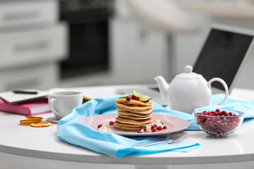 Delicious breakfast served on table with laptop. Food blog