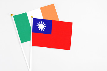 Taiwan and Ireland stick flags on white background. High quality fabric, miniature national flag. Peaceful global concept.White floor for copy space