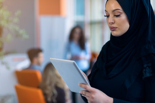 pretty modern Arabian woman with tablet computer