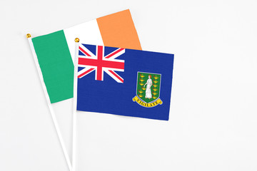 Fototapeta premium British Virgin Islands and Ireland stick flags on white background. High quality fabric, miniature national flag. Peaceful global concept.White floor for copy space