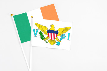 United States Virgin Islands and Ireland stick flags on white background. High quality fabric, miniature national flag. Peaceful global concept.White floor for copy space