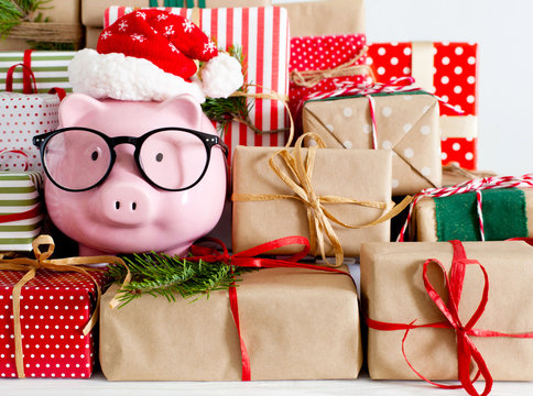 Piggy bank and a lot of gift boxes. Christmas decor. White background. Fir branches.
