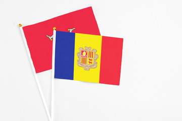 Andorra and Isle Of Man stick flags on white background. High quality fabric, miniature national flag. Peaceful global concept.White floor for copy space.