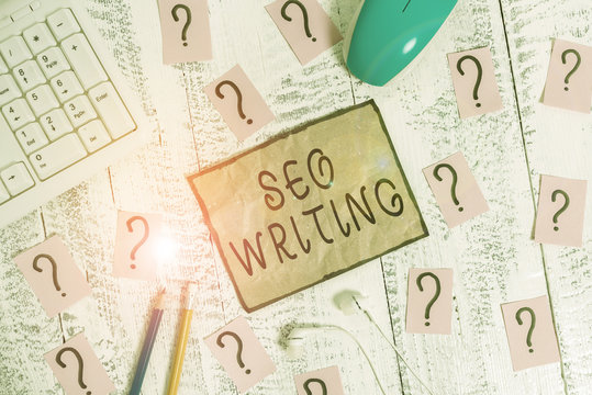 Conceptual hand writing showing Seo Writing. Concept meaning grabbing the attention of the search engines using specific word Writing tools and scribbled paper on top of the wooden table